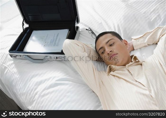 Businessman lying on the bed