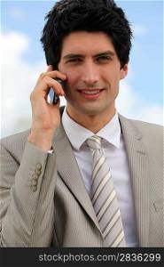 Businessman making a call outdoors
