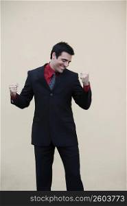 Businessman making a fist and smiling