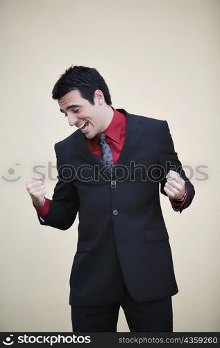 Businessman making a fist and smiling