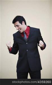 Businessman making a fist and smiling