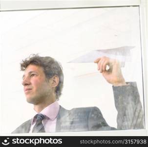 Businessman making a paper aeroplane