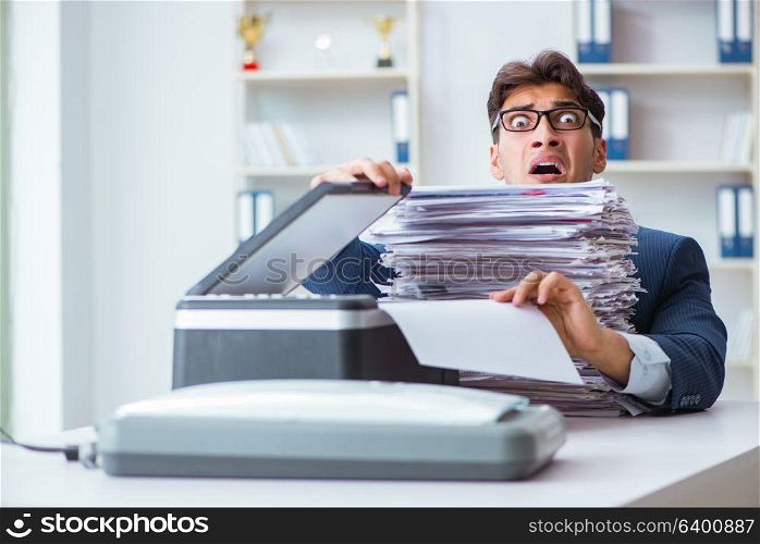 Businessman making copies in copying machine