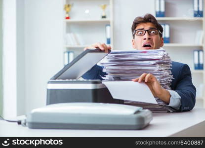 Businessman making copies in copying machine