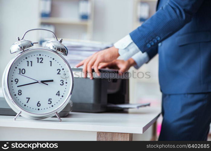 Businessman making copies in copying machine