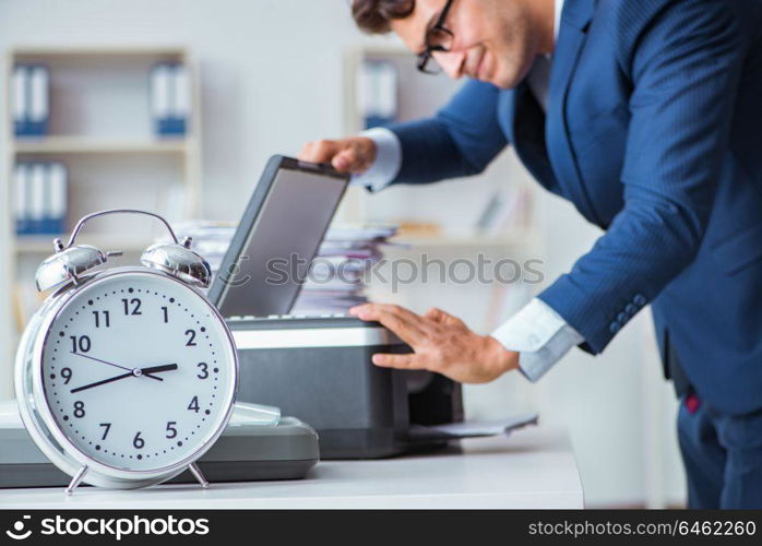 Businessman making copies in copying machine