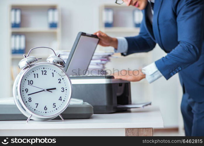 Businessman making copies in copying machine