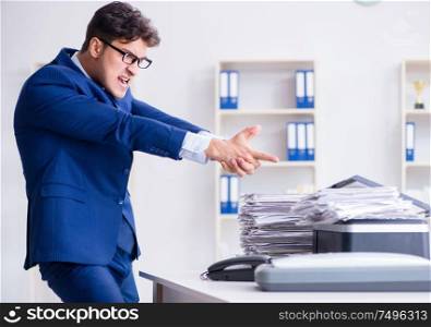 Businessman making copies in copying machine. The businessman making copies in copying machine