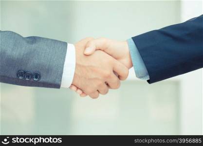 Businessman making handshake, vintage color tone