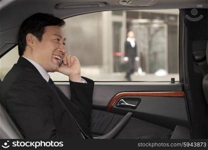 businessman making phone call in the car