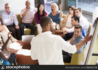 Businessman Making Presentation To Office Colleagues