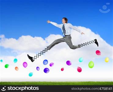 Businessman making wide jump. Businessman in suit jumping with big springs on feet