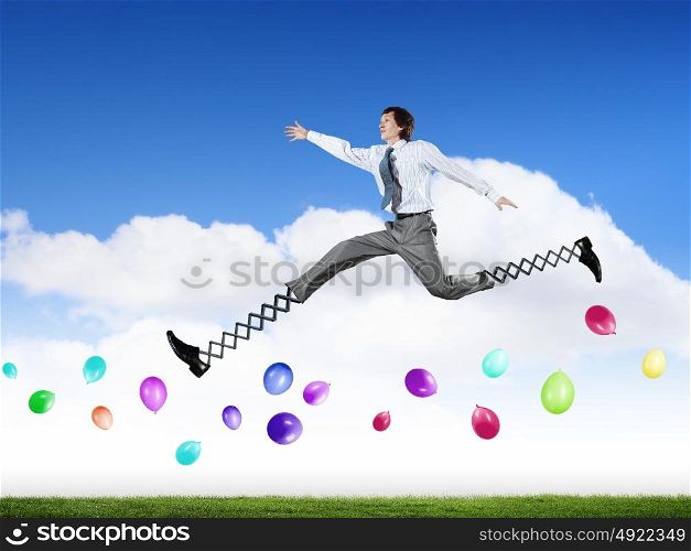 Businessman making wide jump. Businessman in suit jumping with big springs on feet