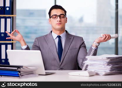 Businessman meditating in the office