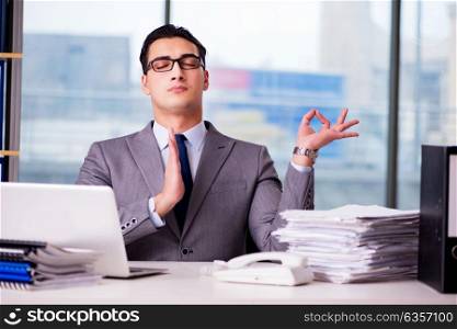 Businessman meditating in the office