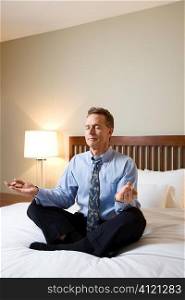 Businessman Meditating on Bed
