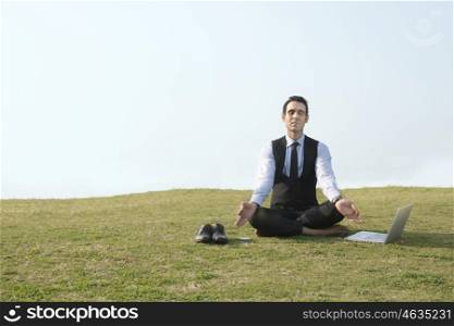 Businessman meditating outdoors , INDIA , DELHI