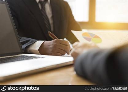 businessman meeting, analyzing and discussing with computer and paperwork document