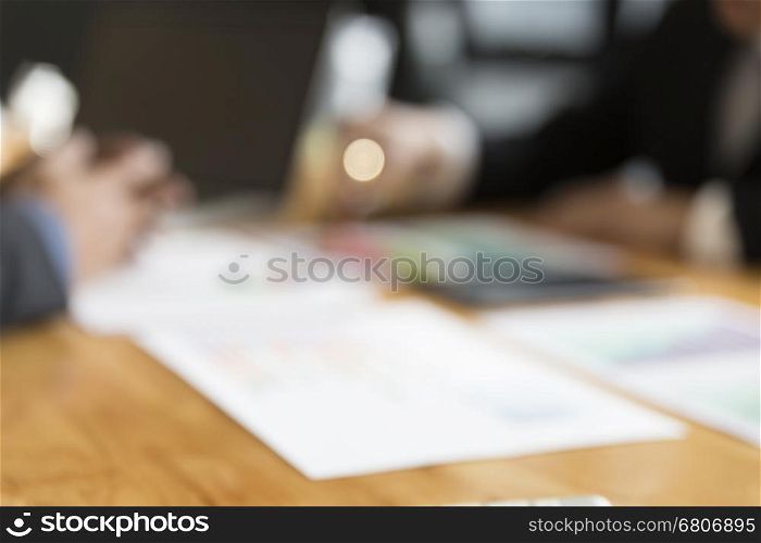 businessman meeting, analyzing and discussing with computer and paperwork document - blur for use as background