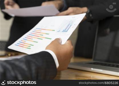 businessman meeting, analyzing and discussing with laptop computer and paperwork document