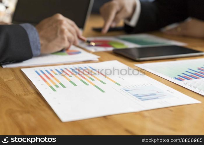businessman meeting, analyzing and discussing with tablet and paperwork document