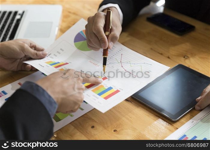 businessman meeting, analyzing and discussing with tablet and paperwork document