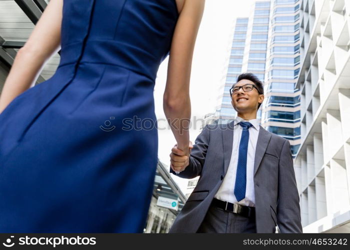 Businessman meeting his colleague outdoors. Nice talk out of the office