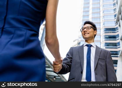 Businessman meeting his colleague outdoors. Nice talk out of the office