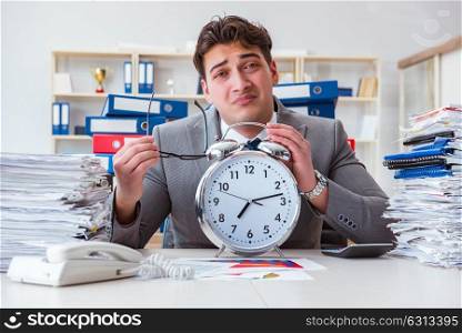 Businessman missing deadlines due to excessive work. The businessman missing deadlines due to excessive work