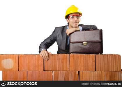 Businessman near brick wall