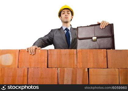 Businessman near brick wall