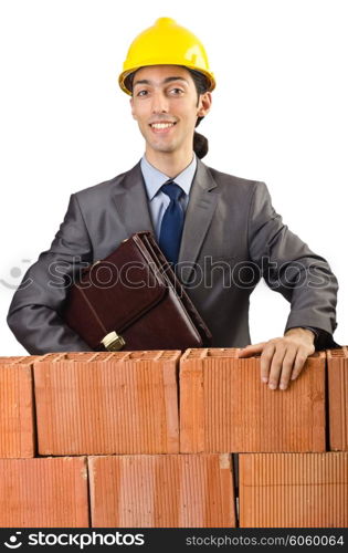 Businessman near brick wall