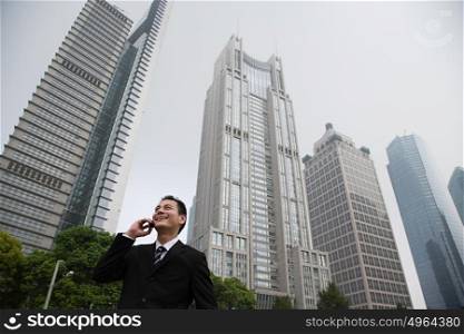 Businessman near skyscrapers