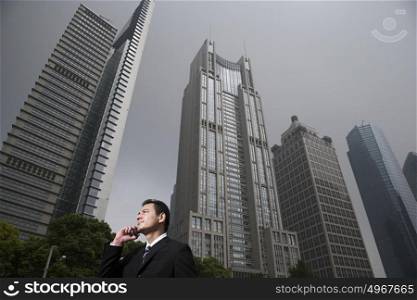 Businessman near skyscrapers