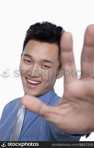 Businessman Obstructing Camera with Hand