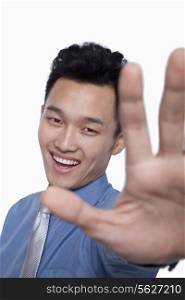 Businessman Obstructing Camera with Hand