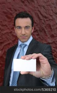 Businessman offering a blank business card