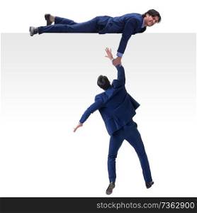 Businessman offering helping hand to falling colleague