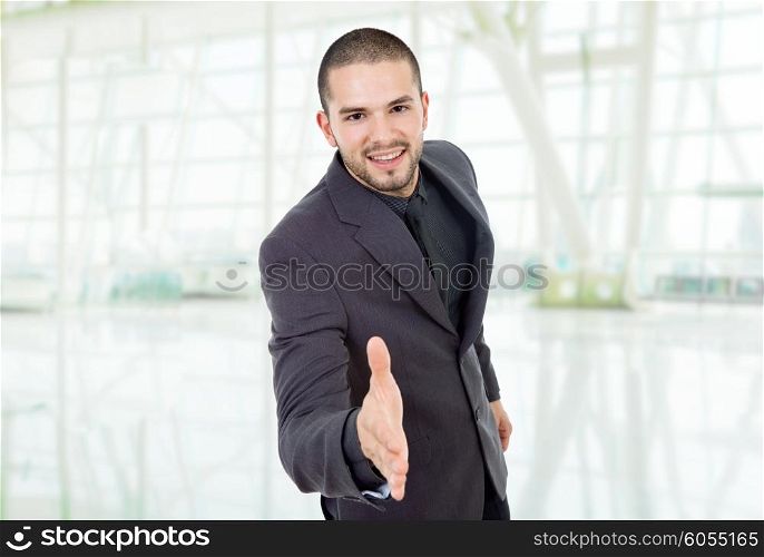 businessman offering to shake the hand, at the office