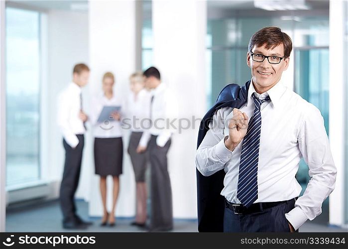 Businessman on a background of office staff