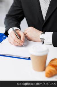 businessman on his coffee break making notes