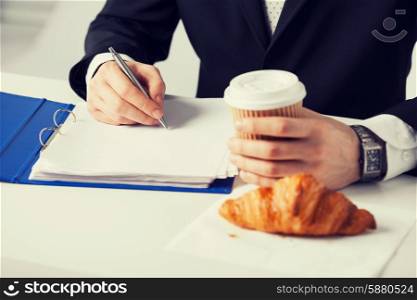 businessman on his coffee break making notes