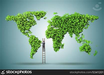 Businessman on ladder in green environment concept