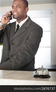 Businessman on Phone at Hotel Reception Desk