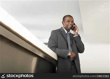 Businessman on Telephone at Counter