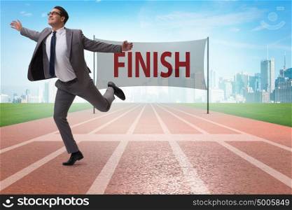 Businessman on the finishing line in competition concept