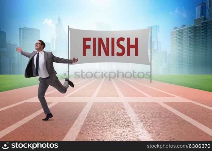 Businessman on the finishing line in competition concept