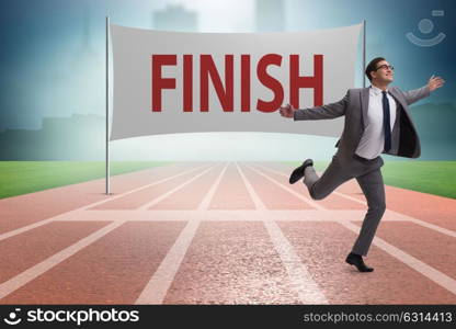 Businessman on the finishing line in competition concept