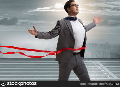 Businessman on the finishing line in competition concept