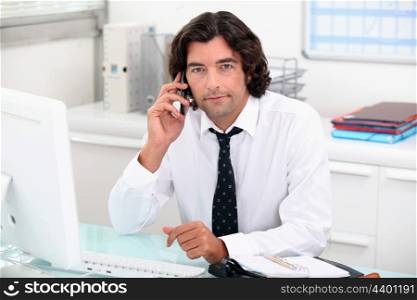 Businessman on the phone at his desk
